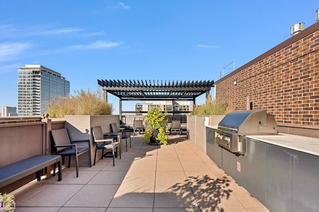 view of patio / terrace with an outdoor kitchen, a pergola, and a grill