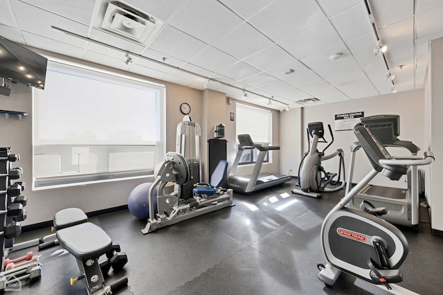 exercise room featuring visible vents and track lighting