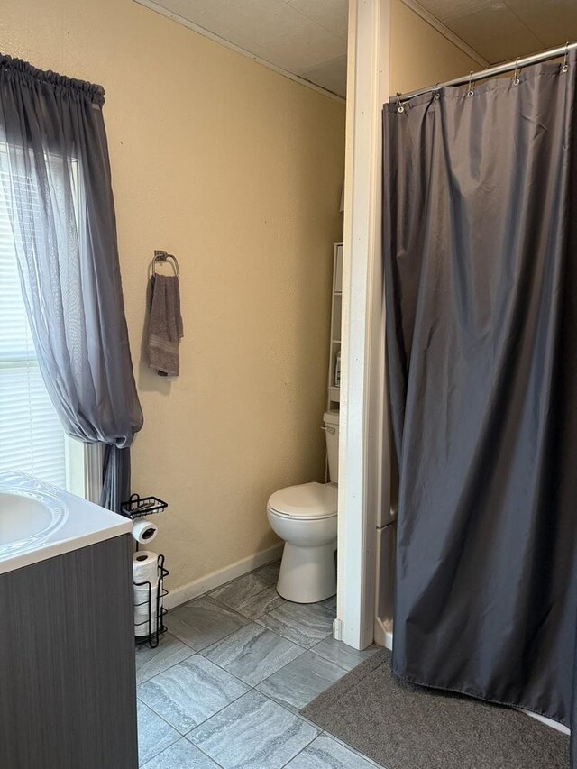 bedroom featuring crown molding, baseboards, wood finished floors, and visible vents