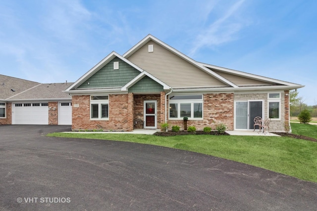 13 Briden Ln Unit 13, Sycamore, IL 60178 - craftsman house featuring an attached garage, driveway, a front lawn, and brick siding