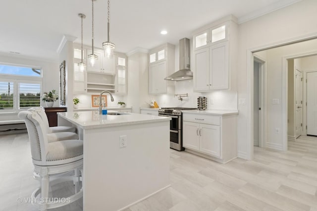 13 Briden Ln Unit 13, Sycamore, IL 60178 - kitchen featuring wall chimney exhaust hood, double oven range, a sink, light countertops, and ornamental molding