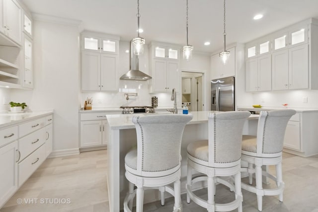 13 Briden Ln Unit 13, Sycamore, IL 60178 - kitchen featuring stainless steel fridge with ice dispenser, wall chimney range hood, an island with sink, white cabinets, and recessed lighting