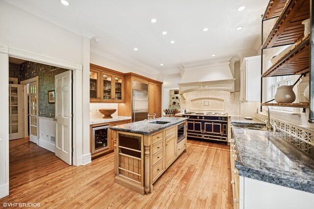 475 Maple St, Winnetka, IL 60093 - kitchen featuring built in appliances, custom range hood, beverage cooler, crown molding, and light wood finished floors