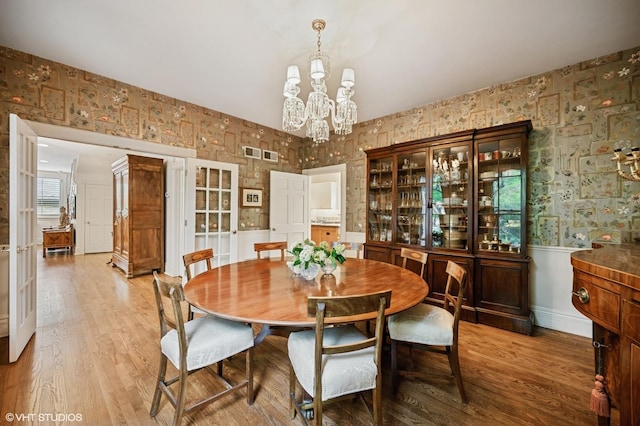 475 Maple St, Winnetka, IL 60093 - dining space with a chandelier, a wainscoted wall, wallpapered walls, wood finished floors, and french doors