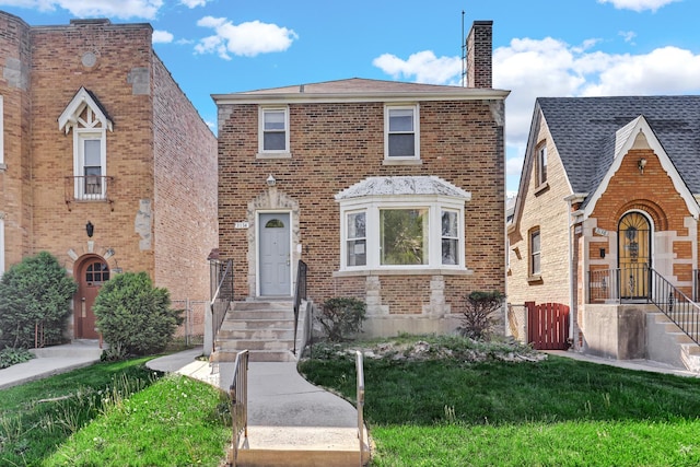 3134 N Mason Ave, Chicago, IL 60634 - view of front of home with a chimney, brick siding, and a front lawn
