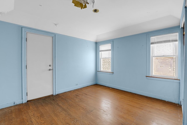 3134 N Mason Ave, Chicago, IL 60634 - empty room with wood finished floors, vaulted ceiling, and baseboards