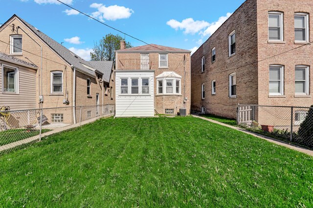 3134 N Mason Ave, Chicago, IL 60634 - back of house featuring central AC unit and brick siding