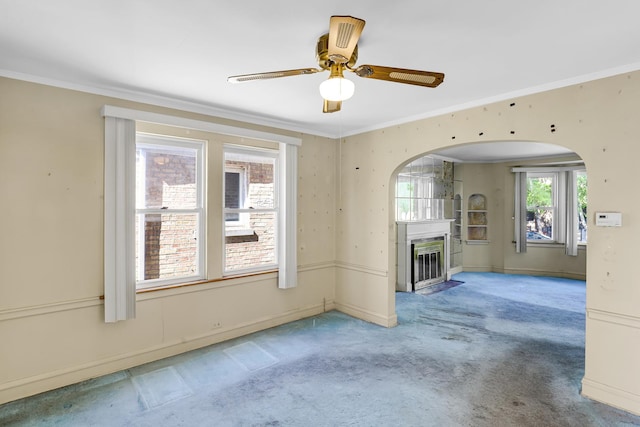 3134 N Mason Ave, Chicago, IL 60634 - unfurnished living room with crown molding, arched walkways, carpet flooring, a fireplace with flush hearth, and ceiling fan