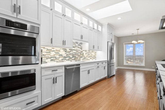1 Renaissance Pl Unit 1Ph, Palatine, IL 60067 - kitchen with appliances with stainless steel finishes, a sink, light countertops, backsplash, and recessed lighting
