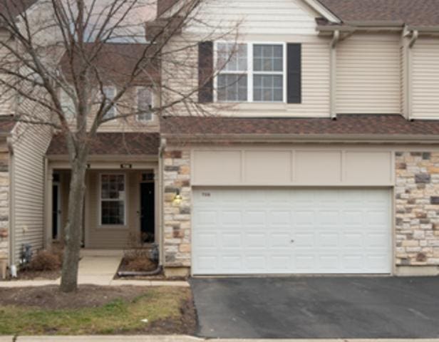 738 Dillon Ct, Grayslake, IL 60030 - view of front facade with asphalt driveway, stone siding, and an attached garage