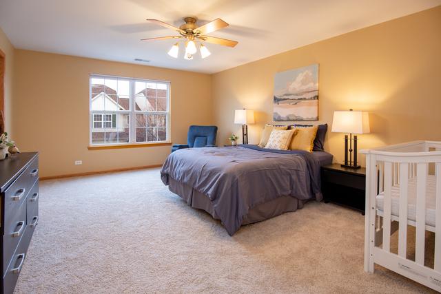 738 Dillon Ct, Grayslake, IL 60030 - bedroom featuring light colored carpet, baseboards, and ceiling fan