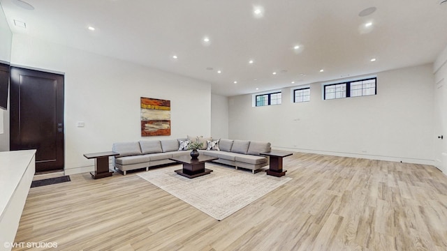 living area featuring light wood-style floors and recessed lighting
