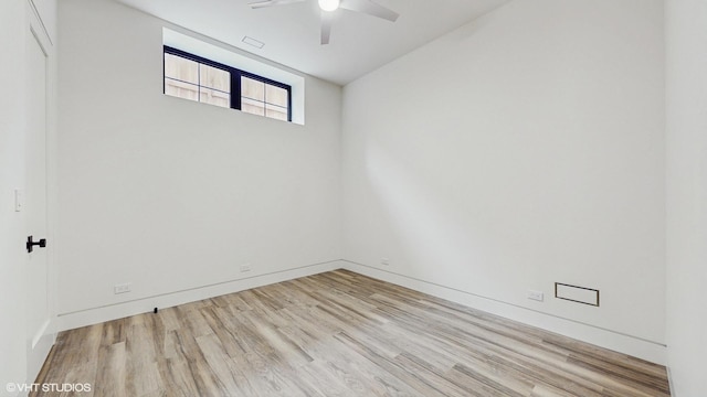 empty room with baseboards, wood finished floors, and ceiling fan