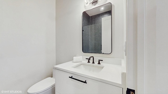 bathroom with toilet and vanity