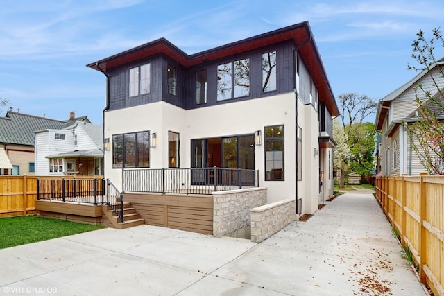 exterior space with stucco siding, a patio, and a fenced backyard