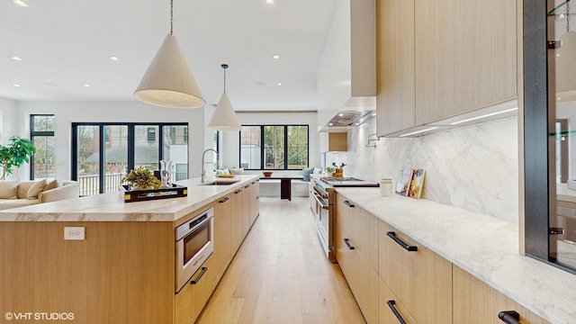 kitchen with light brown cabinetry, modern cabinets, and stainless steel appliances