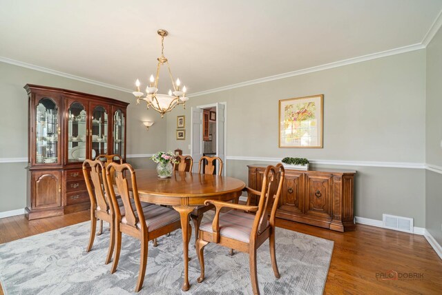 1878 Hackberry Ln, Lake Forest, IL 60045 - dining space with a chandelier, wood finished floors, ornamental molding, and baseboards