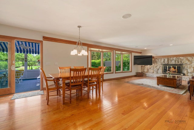 1878 Hackberry Ln, Lake Forest, IL 60045 - dining space with light wood finished floors, a stone fireplace, baseboards, a chandelier, and recessed lighting