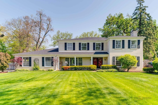 1878 Hackberry Ln, Lake Forest, IL 60045 - view of front of property with brick siding, a front yard, and a chimney