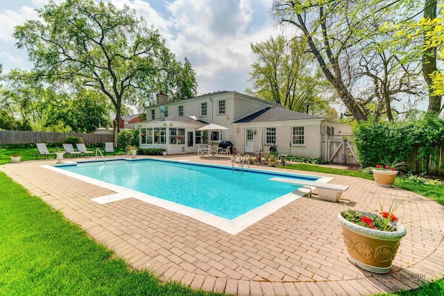 1878 Hackberry Ln, Lake Forest, IL 60045 - view of pool featuring a patio area, a diving board, and a sunroom