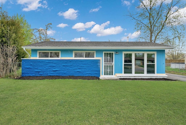 1401 Stanley Blvd, Calumet City, IL 60409 - view of front facade featuring fence, stone siding, and a front yard