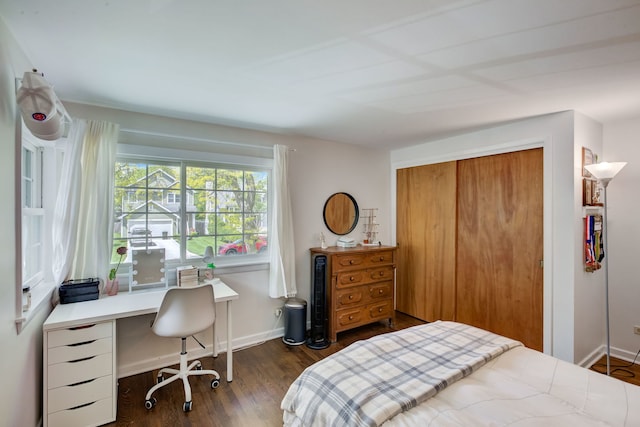 627 Beaver Rd, Glenview, IL 60025 - bedroom featuring baseboards, a closet, and dark wood-style flooring