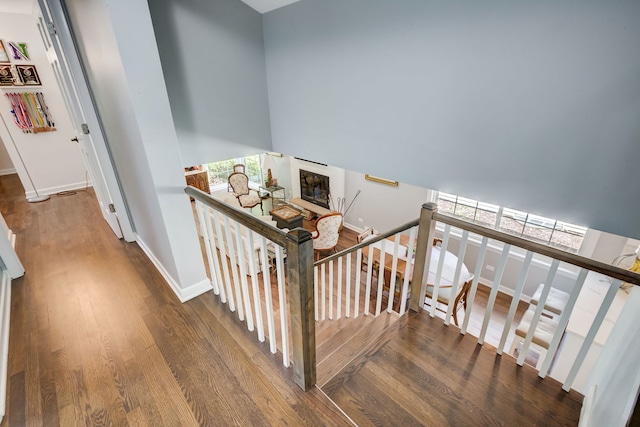 627 Beaver Rd, Glenview, IL 60025 - stairway featuring baseboards, a glass covered fireplace, and wood finished floors