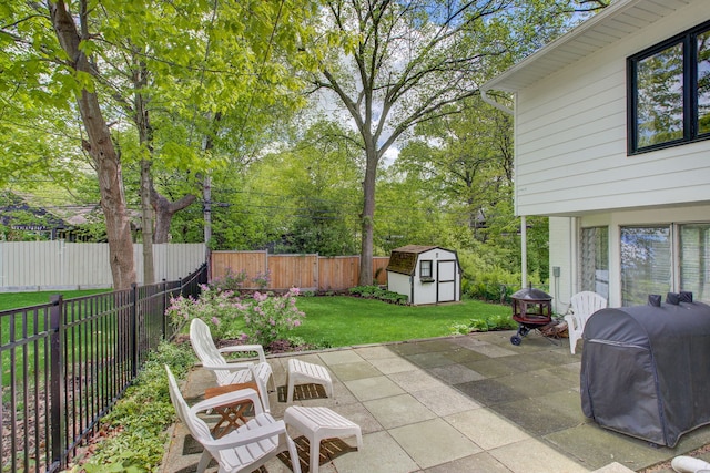 627 Beaver Rd, Glenview, IL 60025 - view of patio / terrace featuring a fenced backyard, an outdoor structure, grilling area, and a shed