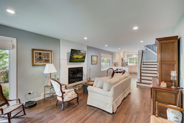 627 Beaver Rd, Glenview, IL 60025 - living area featuring recessed lighting, a brick fireplace, wood finished floors, and stairway