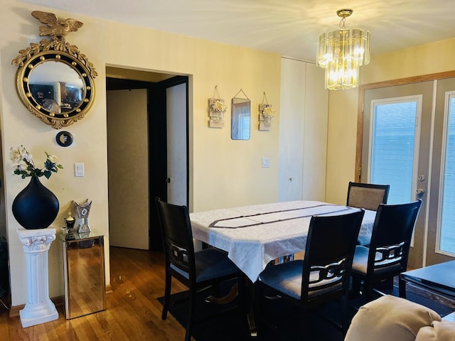 dining room featuring a chandelier and wood finished floors