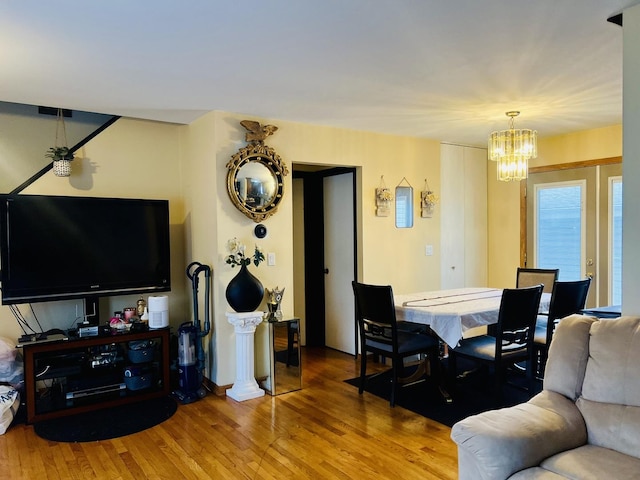 living room with wood finished floors and a chandelier