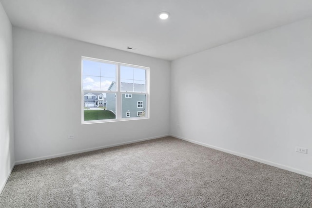 spare room with recessed lighting, visible vents, carpet floors, and baseboards