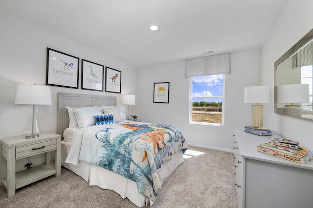 bedroom with baseboards, recessed lighting, and light carpet