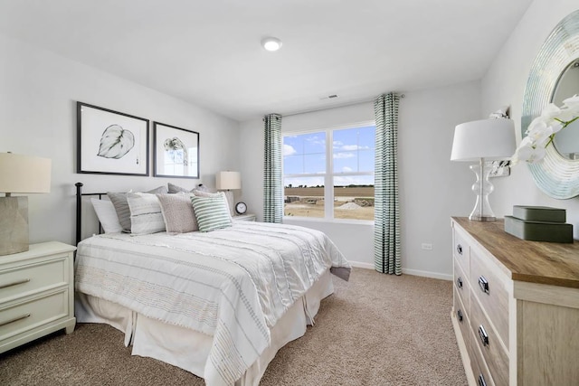 bedroom with light colored carpet, visible vents, and baseboards