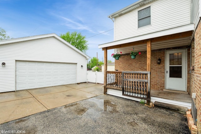 detached garage with a porch