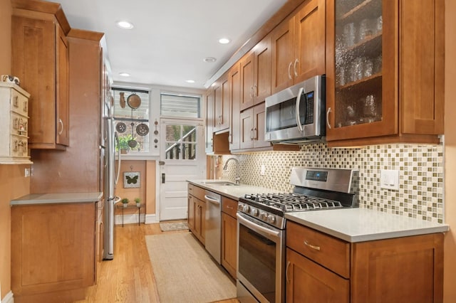 725 Erie St Unit 1D, Oak Park, IL 60302 - kitchen with appliances with stainless steel finishes, a sink, brown cabinets, light wood-style floors, and recessed lighting