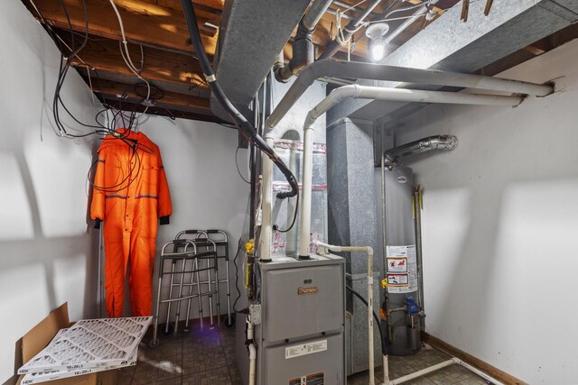 utility room featuring gas water heater
