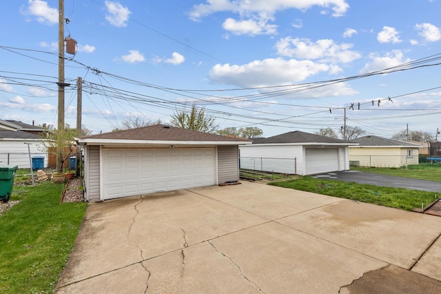 detached garage featuring fence