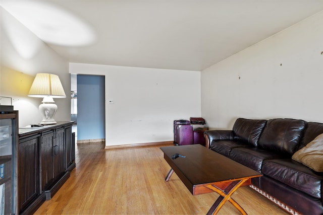 living room with baseboards and light wood-style floors
