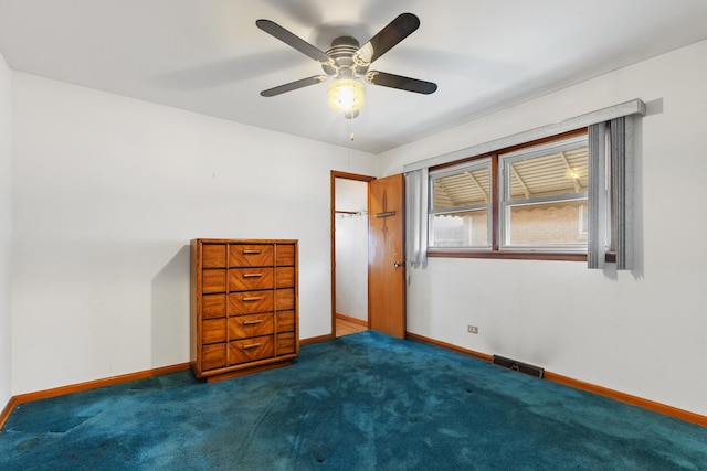 unfurnished bedroom with carpet flooring, visible vents, and baseboards