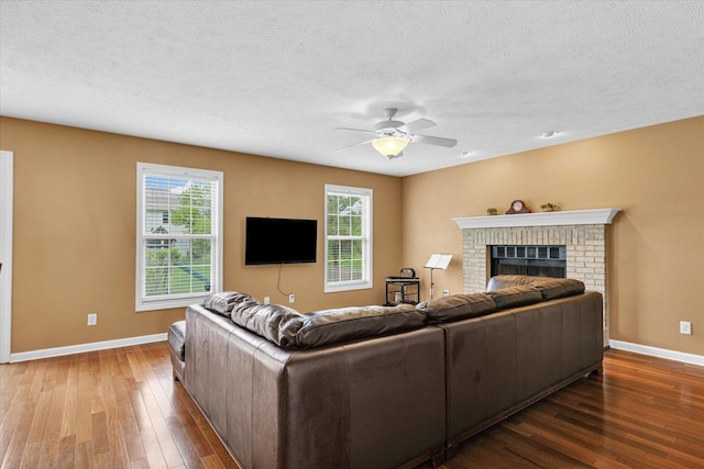 4603 Stonebridge Dr, Champaign, IL 61822 - living area featuring hardwood / wood-style floors, a textured ceiling, a fireplace, a ceiling fan, and baseboards