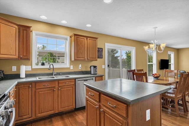 4603 Stonebridge Dr, Champaign, IL 61822 - kitchen with a sink, dark countertops, a notable chandelier, stainless steel dishwasher, and range