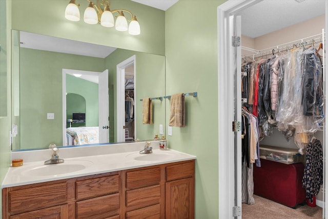 4603 Stonebridge Dr, Champaign, IL 61822 - ensuite bathroom featuring double vanity, ensuite bath, a walk in closet, and a sink