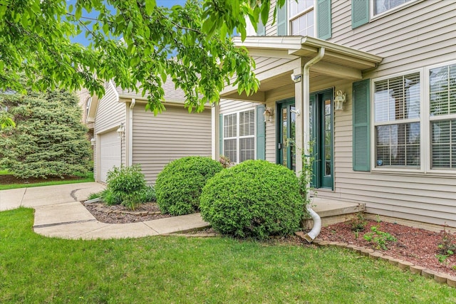 4603 Stonebridge Dr, Champaign, IL 61822 - view of exterior entry with a yard and a garage