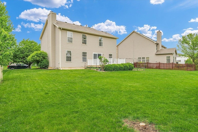 4603 Stonebridge Dr, Champaign, IL 61822 - rear view of house featuring a yard, a chimney, and fence