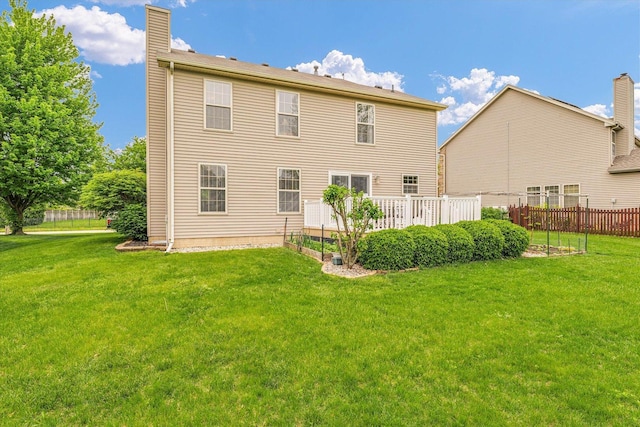 4603 Stonebridge Dr, Champaign, IL 61822 - back of house featuring fence, a chimney, and a lawn