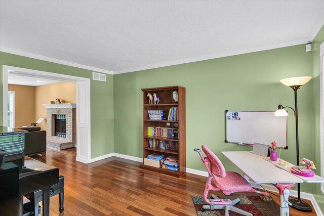4603 Stonebridge Dr, Champaign, IL 61822 - office area featuring wood finished floors, visible vents, a fireplace, crown molding, and baseboards
