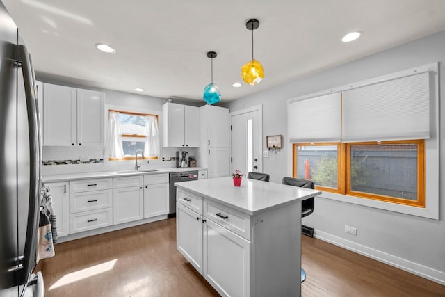kitchen featuring white cabinetry, appliances with stainless steel finishes, a sink, and dark wood finished floors