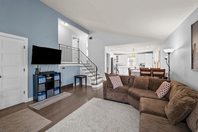 living area featuring stairway, vaulted ceiling, recessed lighting, and wood finished floors