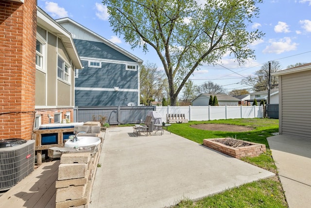 view of patio with central air condition unit and a fenced backyard